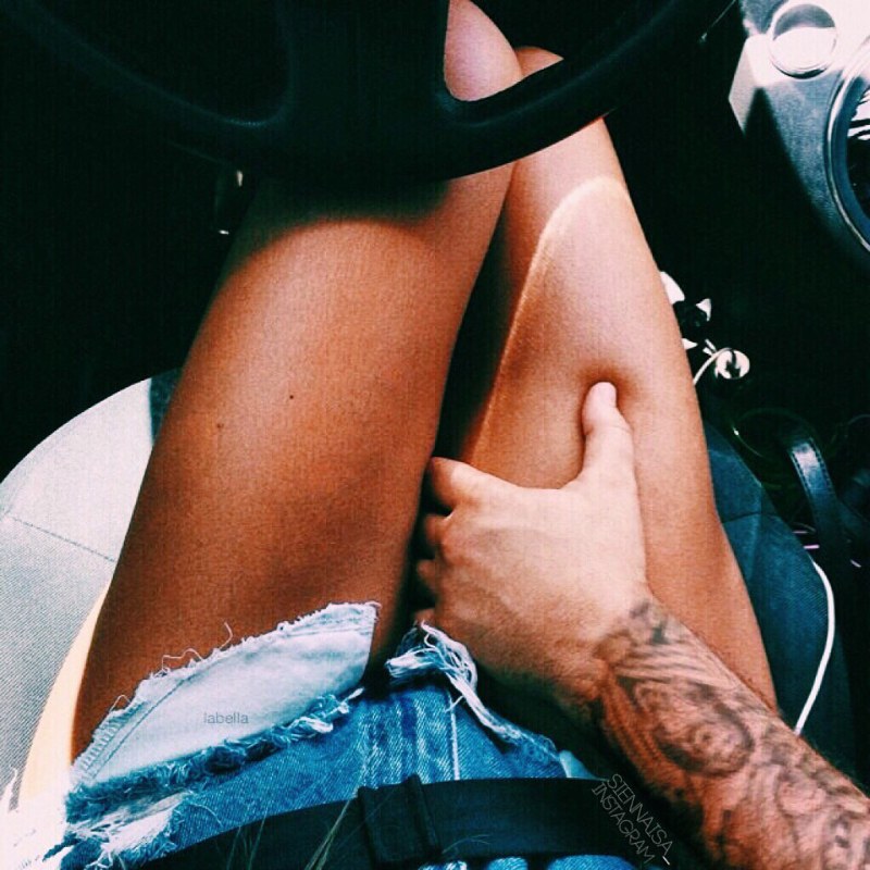 Men's hand on a knee in a car