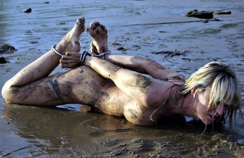 Naked women bathe in the mud