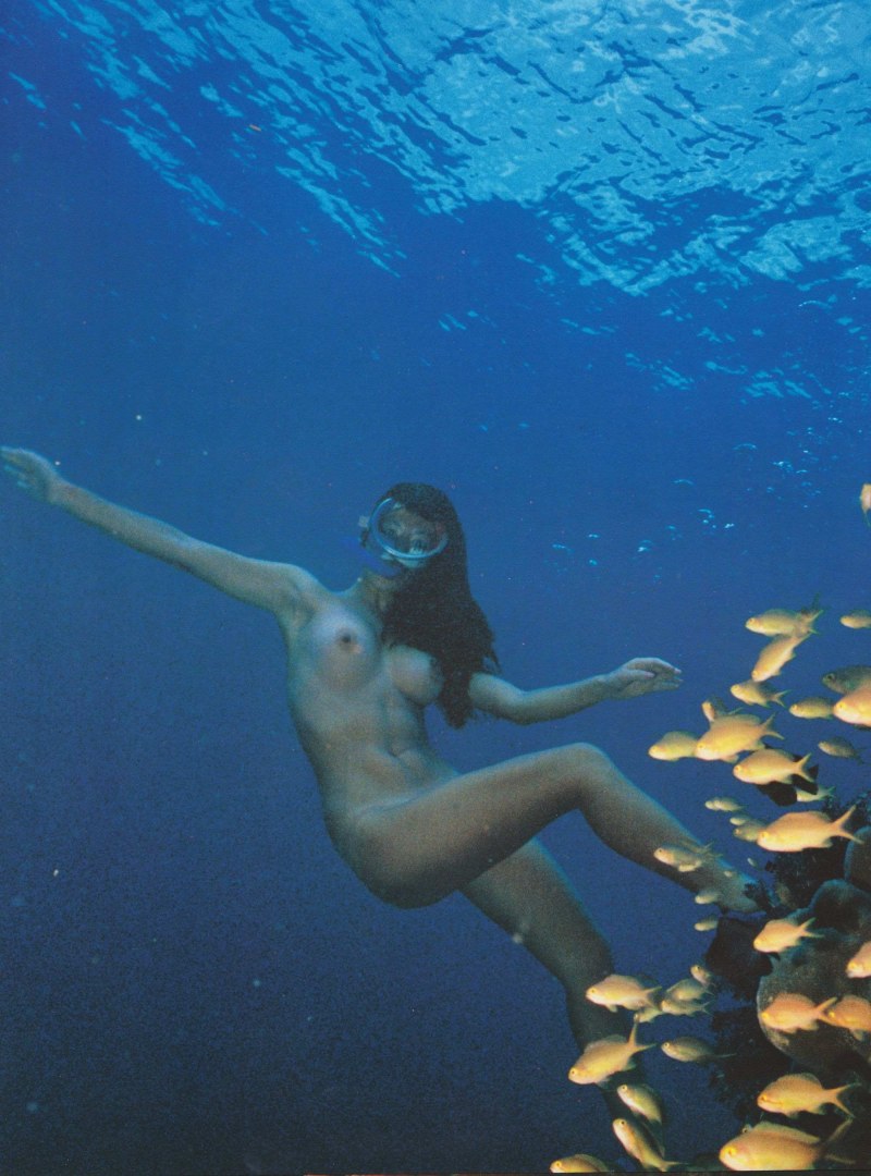 Naked women with flippers underwater