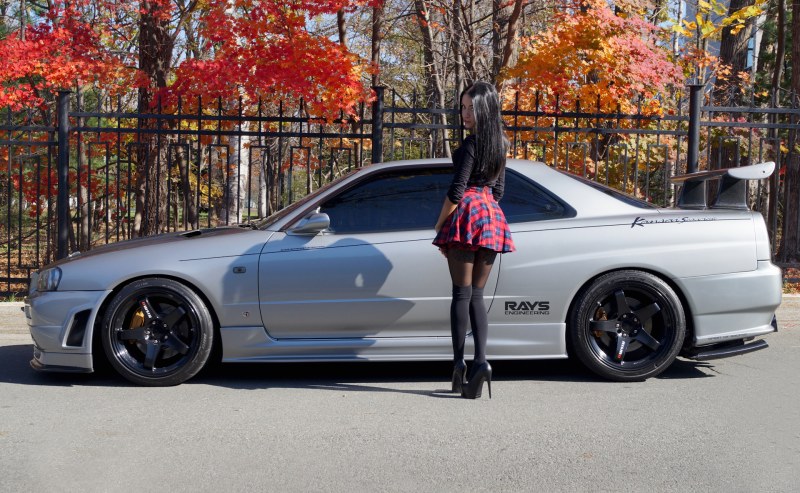 Brunettes in a red swimsuit at sunset