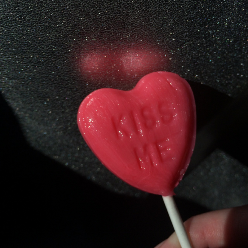 Girl with Chupa Chups in her mouth