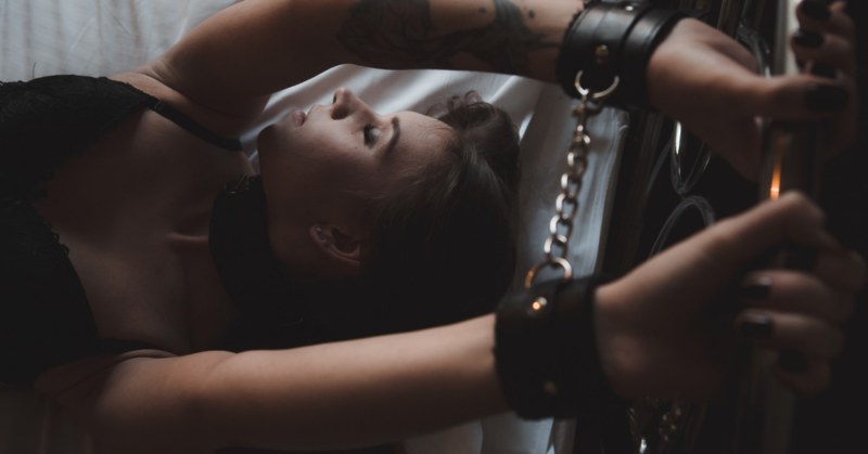 The girl is tied to the bed