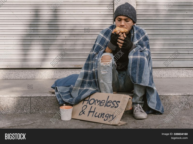 A naked beggar lies on the road
