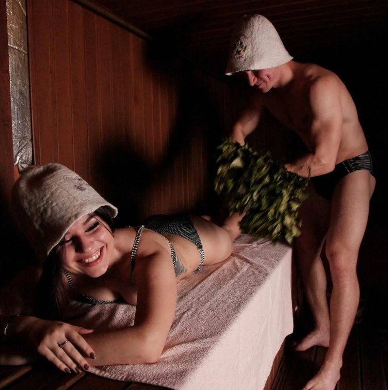 Girl in a sauna with a broom