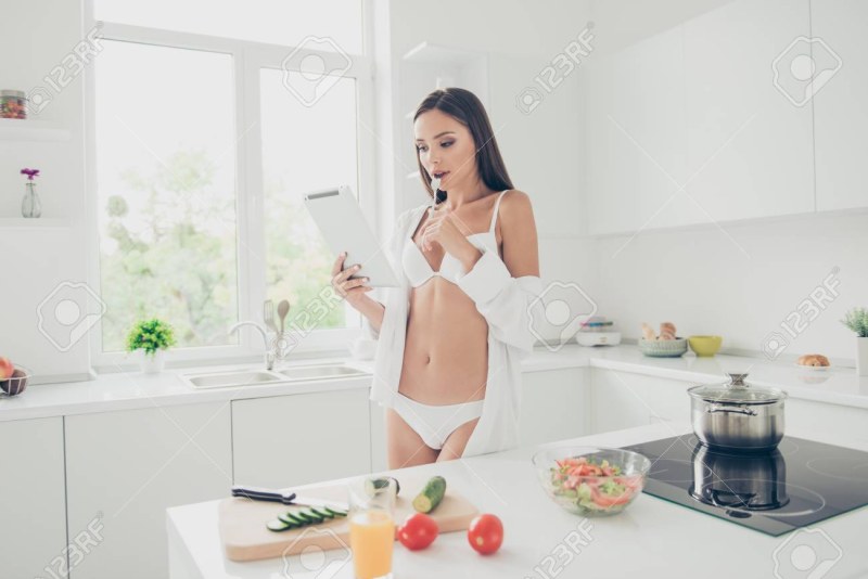 In a white bra in the kitchen