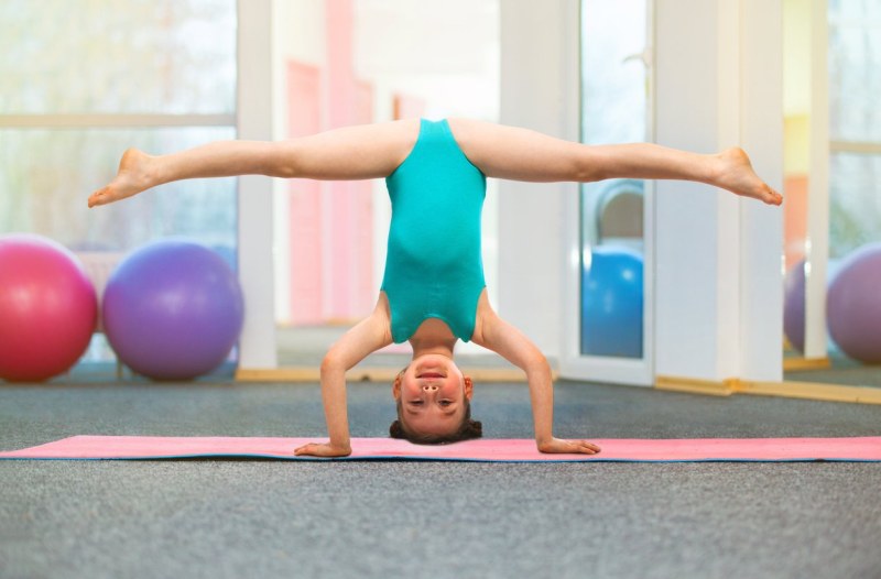 Little girl stands on her head