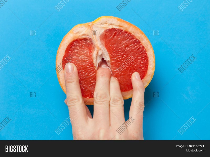 Grapefruit in the section with fingers