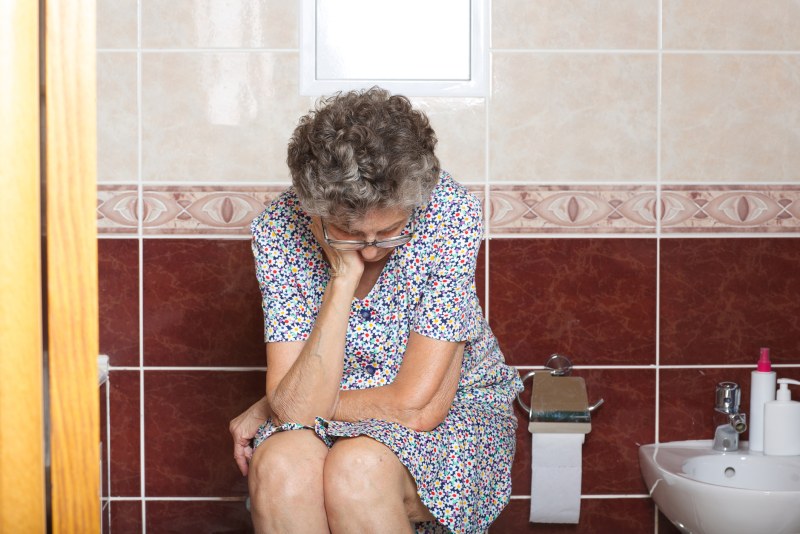 Elderly woman on the toilet