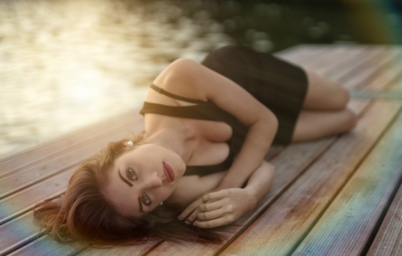 Girl in the dress lies on her side