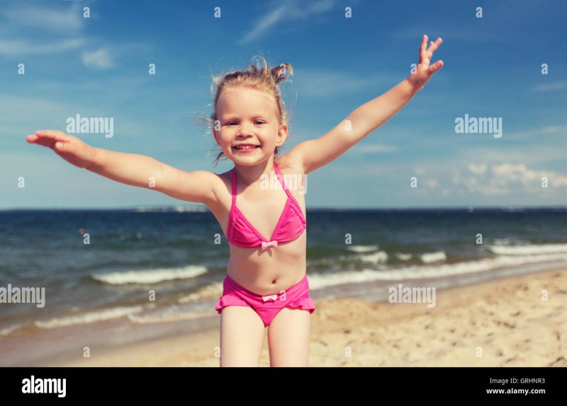 Young girls on the beach paw