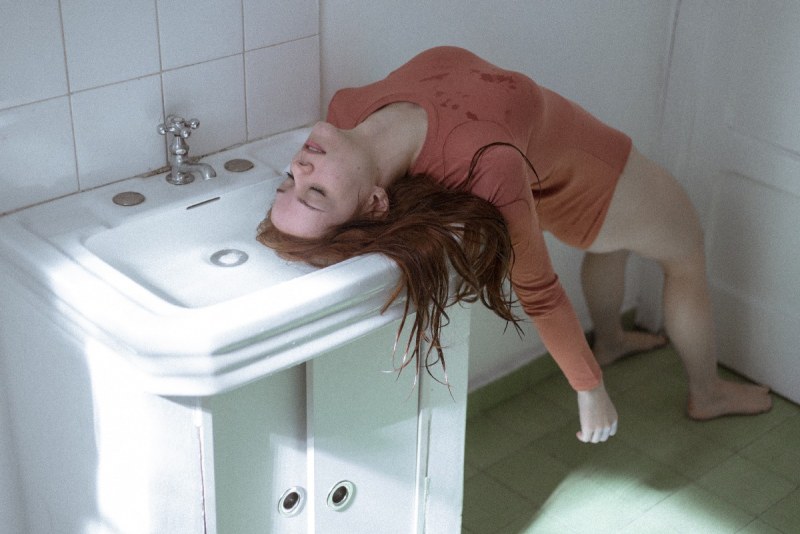 The girl on the toilet is unconscious