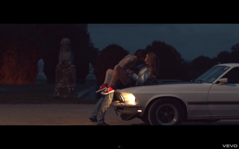 A guy with a girl on a hood