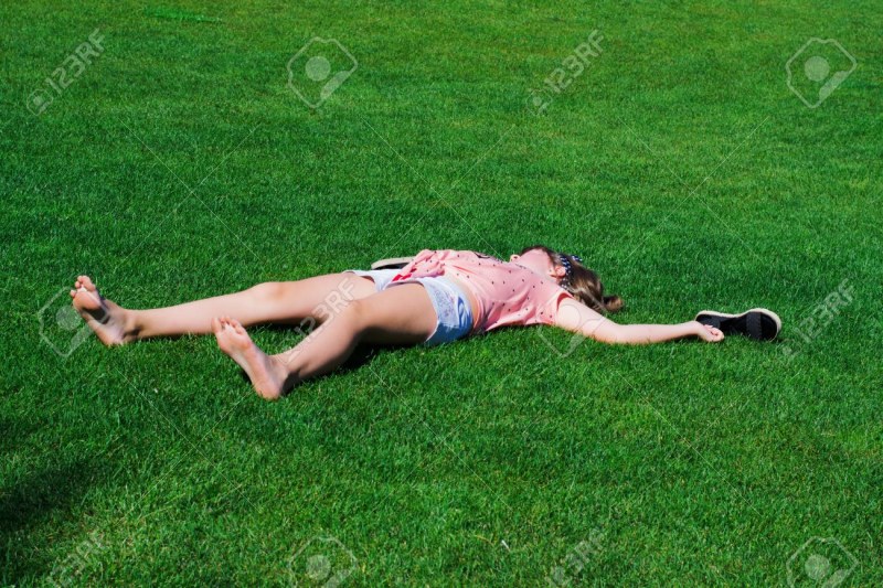 Barefoot Girl Lying on the Grass
