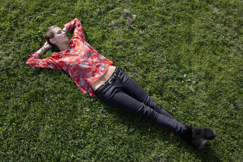 Lady lies on the grass of the chest