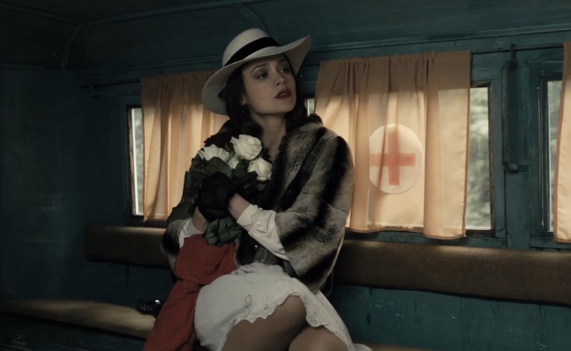 Two people sit in the field