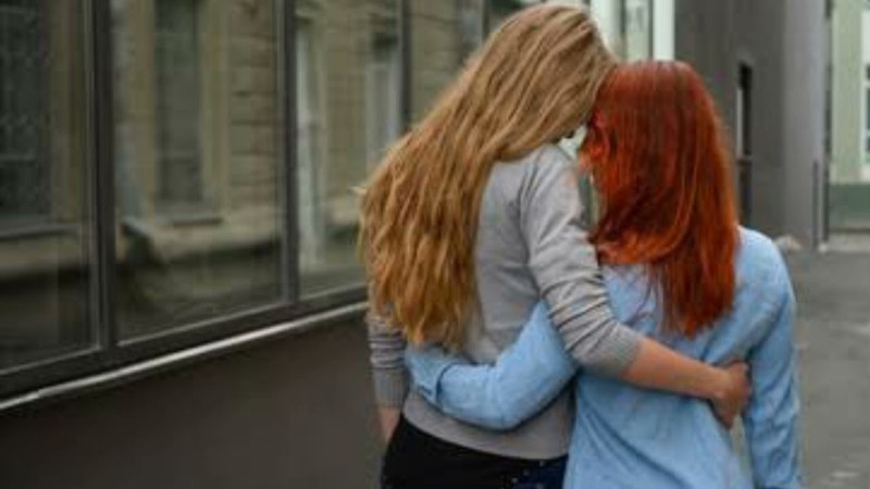 Same Sex Lesbian Couple Hug in Stone House