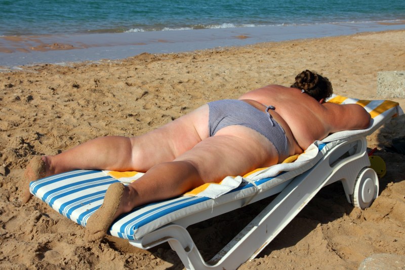 Fat woman on a deck chair