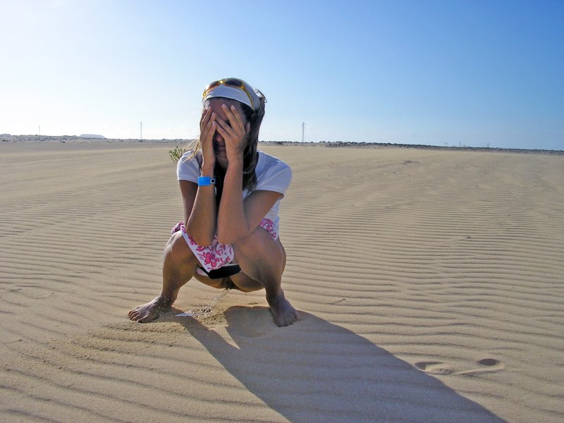 Woman Pees on Beach