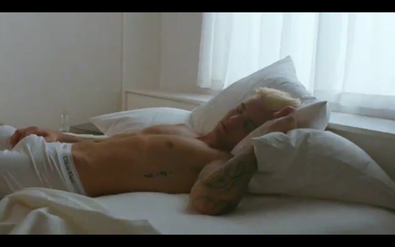 A guy in his underpants on the bed