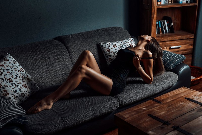 The girl lies on the couch