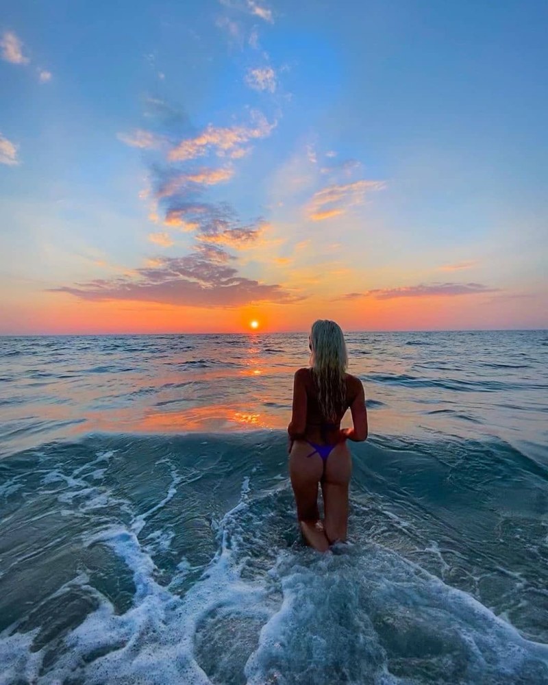 Naked women hide on the beach