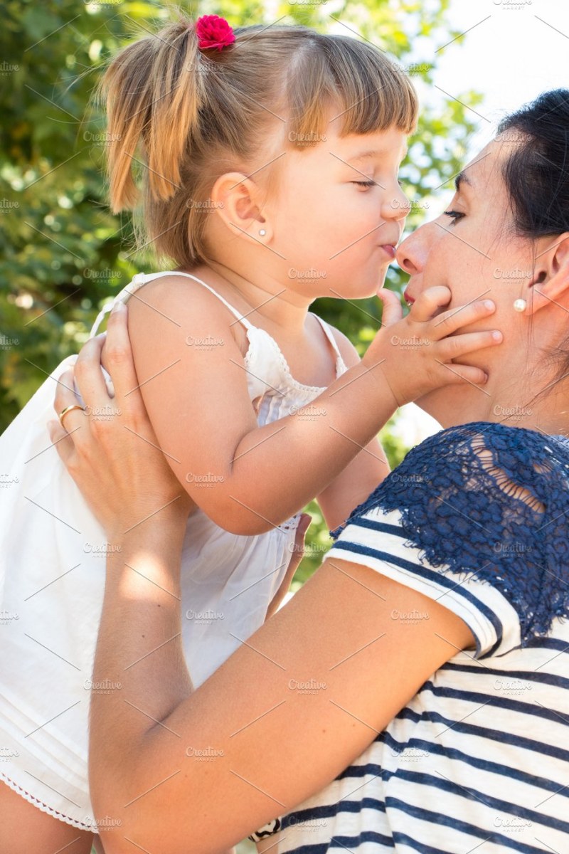The guy kisses the girl in bed