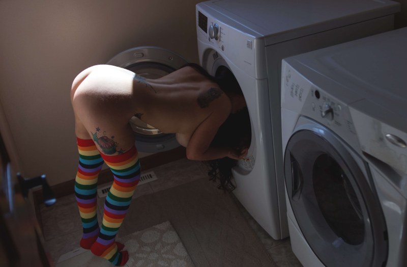 Naked on a washing machine