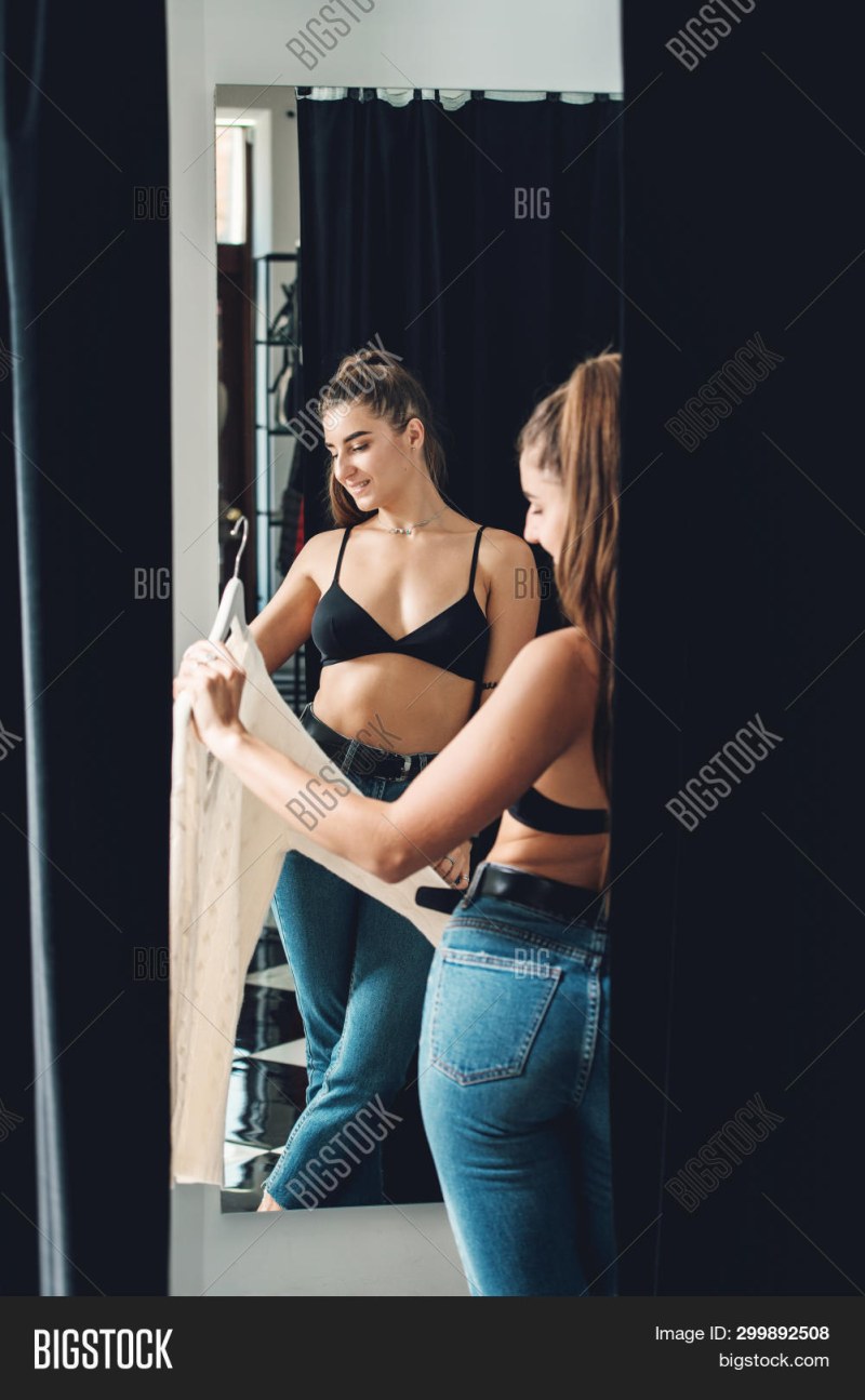 Girl in a black bra in the fitting room