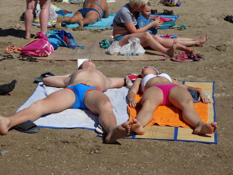 Girls sunbathe on the beach in Anapa
