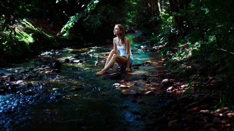 Girl in the forest by the water