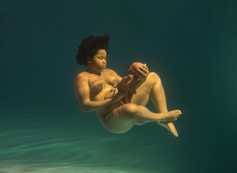 Naked pregnant woman under water