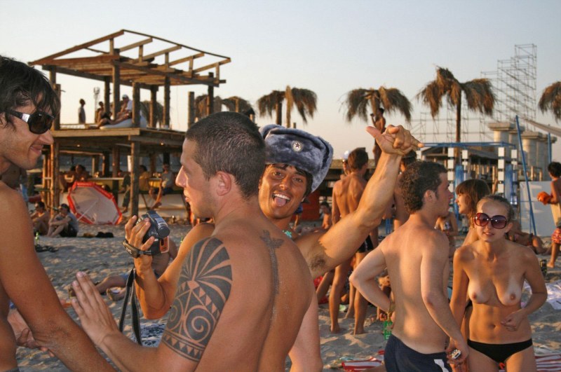 Guys and girls on a nudist beach