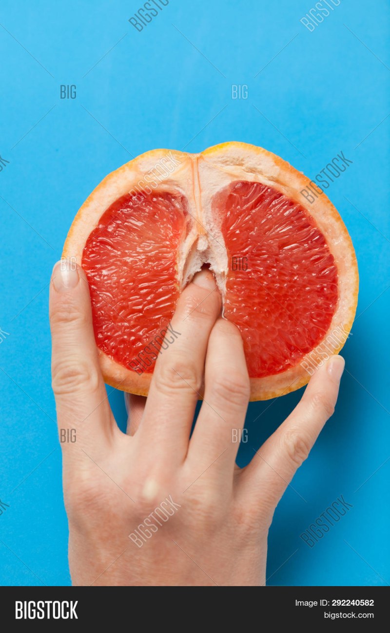 Grapefruit in section with fingers
