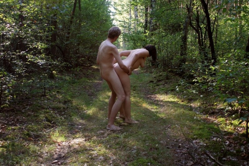 Naked men and women in the forest